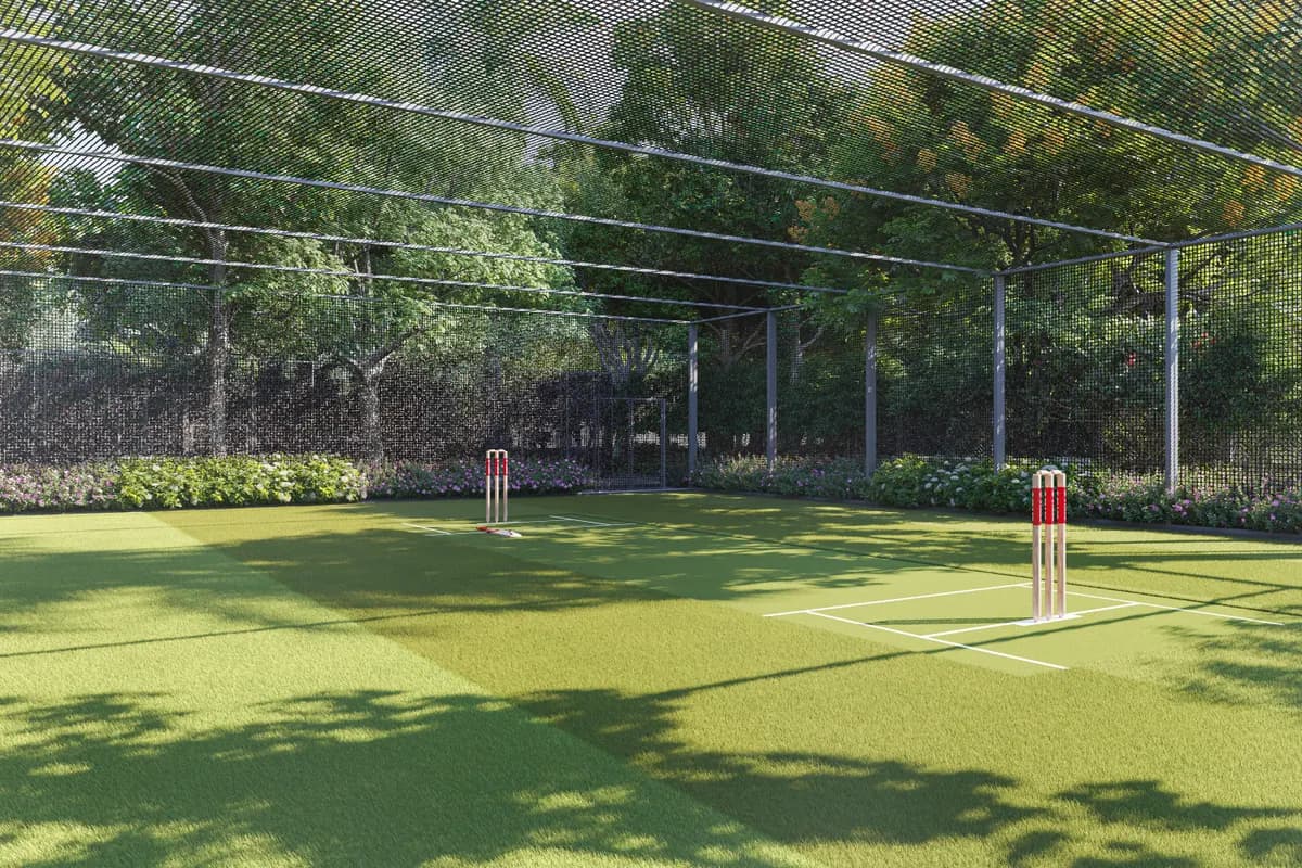 Floodlit cricket turf at Mauli Crystal 35 with stumps set and netted boundary